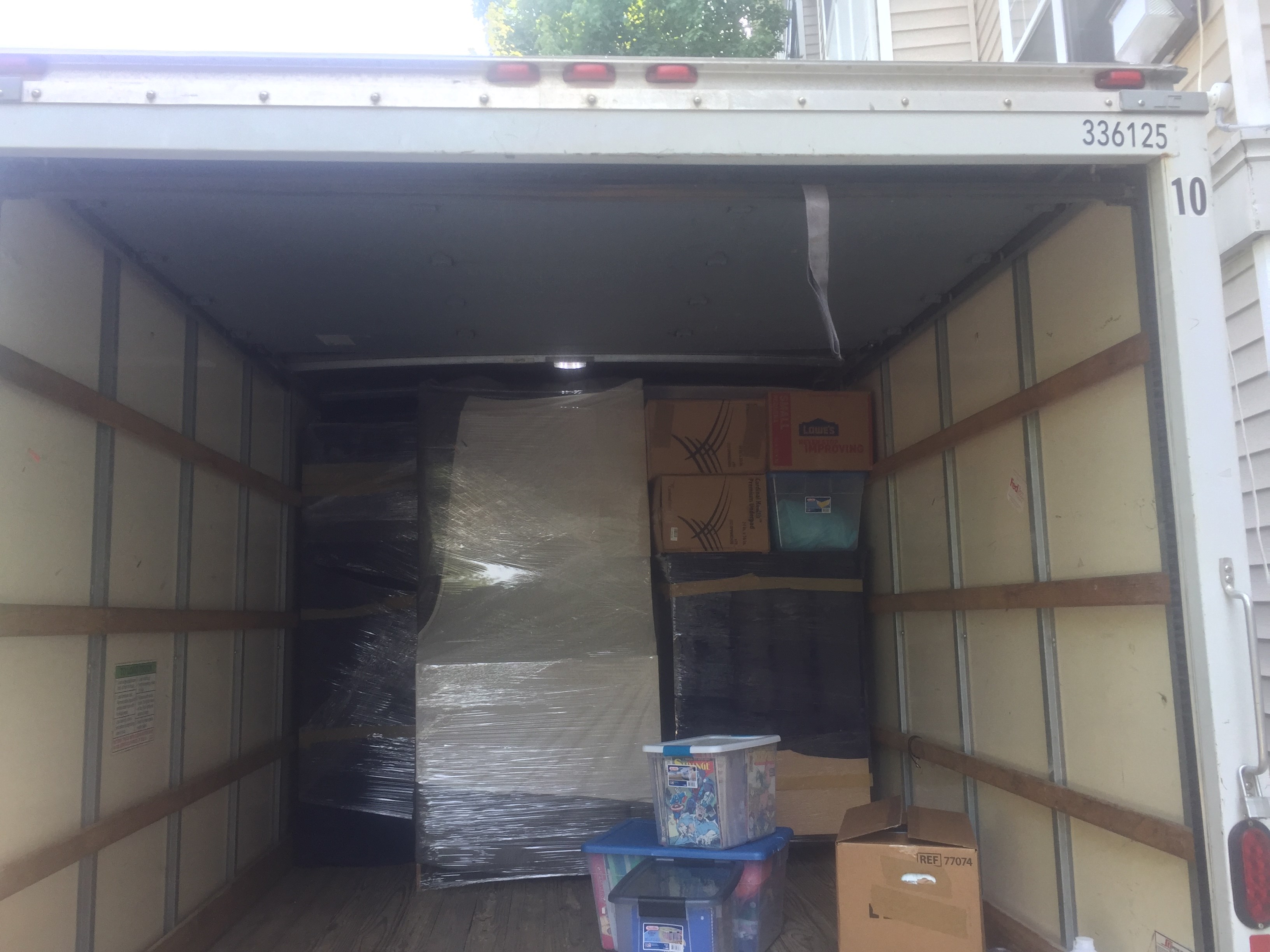 Mover gripping a strap around boxes