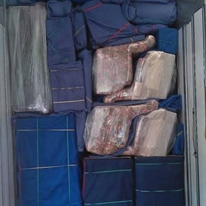 Movers organizing labeled boxes in an empty living room